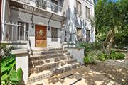 Los Angeles apartment for rent - A white building with a brown door and a metal railing.