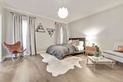 Los Angeles apartment for rent - A bedroom with a bed, a chair, and a rug.