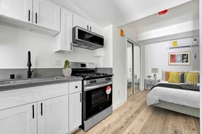 Los Angeles apartment for rent - A modern kitchen with white cabinets and a stainless steel oven.