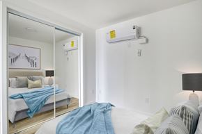 Los Angeles apartment for rent - A bedroom with a bed covered in a blue blanket.