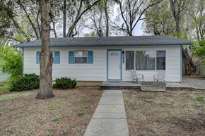 Colorado Springs house for rent - A small house with a blue door and white siding.