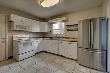 Colorado Springs house for rent - A kitchen with white appliances and cabinets.