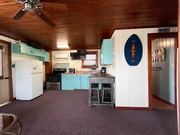 Brazoria house for rent - A kitchen with a ceiling fan and a blue oval sign on the wall.