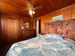Brazoria house for rent - A bedroom with a bed, dresser, and ceiling fan.