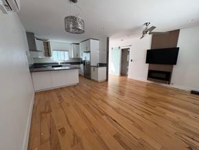 Coronado apartment for rent - A kitchen with wooden floors and white walls.