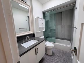 Coronado apartment for rent - A bathroom with a white toilet, sink, and bathtub.