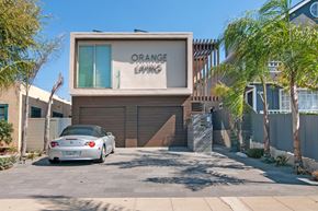 Coronado apartment for rent - A car is parked in front of a building with the sign "ORANGE LAWN".