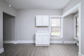 Louisville apartment for rent - A white cabinet sits in a room with light grey walls and a wooden floor.