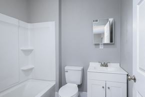Louisville apartment for rent - A white bathroom with a toilet, sink, and bathtub.