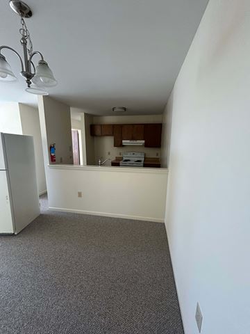 Reading apartment for rent - A kitchen area with a fridge, dishwasher, and a window.