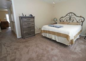 Mountain Home apartment for rent - A bedroom with a bed, dresser, and carpet.
