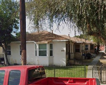 Lynwood apartment for rent - A red truck is parked in front of a white house.