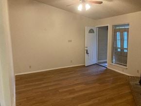 Austin house for rent - A room with wooden flooring and a white door.