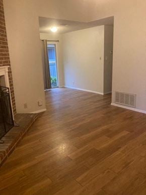 Austin house for rent - A room with wooden floors and a fireplace.