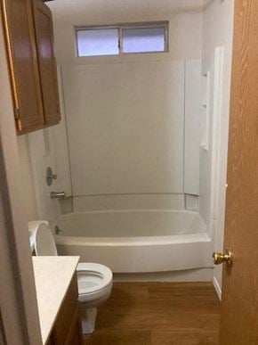Austin house for rent - A white toilet sits next to a white bathtub in a small bathroom.