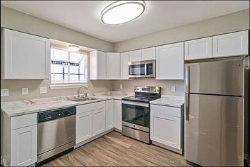 Longmont apartment for rent - A kitchen with white cabinets and stainless steel appliances.