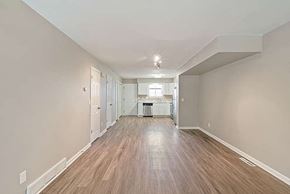 Longmont apartment for rent - A long, empty hallway with wood flooring and white walls.