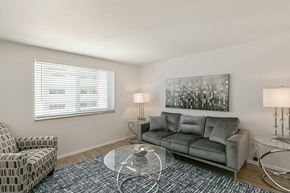 Denver apartment for rent - A bedroom with a bed, carpet, and a ceiling fan.