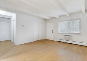 Lakewood apartment for rent - A room with white walls and wooden flooring, with a window covered by blinds.