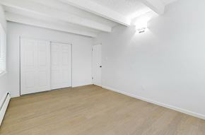 Lakewood apartment for rent - A room with a white wall and a wooden floor.