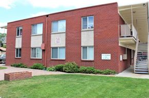 Lakewood apartment for rent - A red brick building with a white sign on the front.