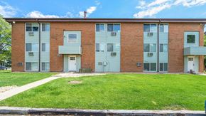 Longmont apartment for rent - A red brick apartment building with a green lawn in front.