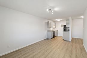 Longmont apartment for rent - A kitchen area with a refrigerator, microwave, and cabinets.