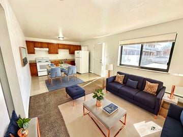 Aurora apartment for rent - A living room with a blue couch and a coffee table.