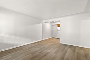Denver apartment for rent - A room with wooden floors and white walls.