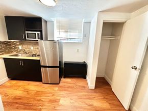Denver apartment for rent - A kitchen with a refrigerator, microwave, and sink.