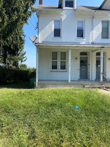 Shillington apartment for rent - A white house with a black door and a window.