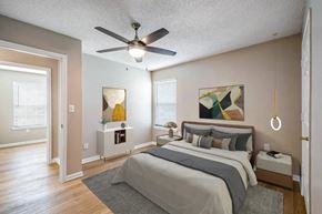 Cleveland apartment for rent - A bedroom with a bed, nightstand, and a ceiling fan.