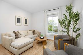 Hudson apartment for rent - A living room with a couch, chair, and a plant.