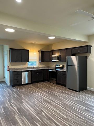 Wernersville apartment for rent - A kitchen with black cabinets and a wooden floor.