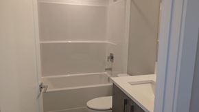 Chestermere house for rent - A white bathroom with a toilet and sink.