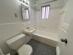 Washington apartment for rent - A white bathroom with a toilet, sink, and bathtub.