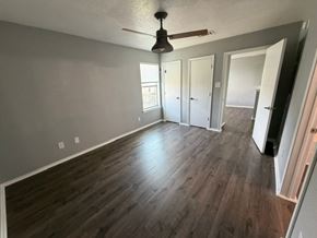 Killeen apartment for rent - A room with wood flooring and a ceiling fan.
