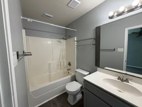 Killeen apartment for rent - A bathroom with a toilet, sink, and shower.