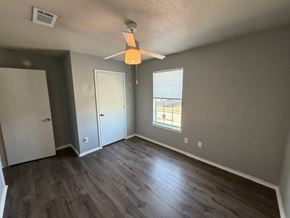 Killeen apartment for rent - A room with a ceiling fan and a window with blinds.