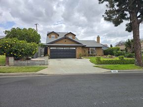 Carson house for rent - A house with a grey garage door and a driveway in front.