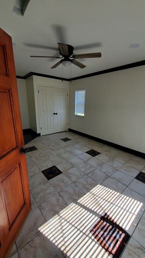 Carson house for rent - A room with a ceiling fan and a door.