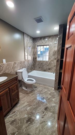 Carson house for rent - A bathroom with a toilet, sink, and bathtub.