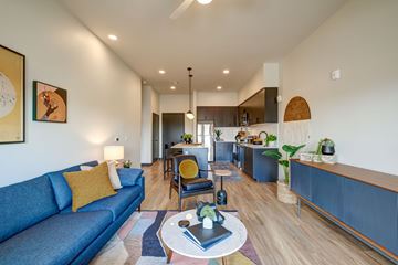 Mesa apartment for rent - A living room with a blue couch and a coffee table.