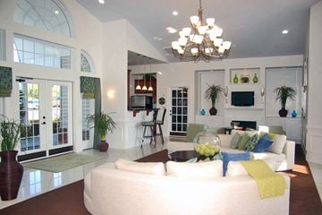Columbia apartment for rent - A living room with a white couch and a chandelier.