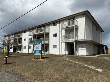 Vanderhoof apartment for rent - A large white apartment building with a sign in front that says "Public Housing".