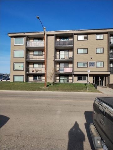 Dawson Creek apartment for rent - A building with a blue sky in the background.