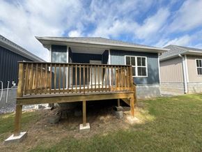 Little Rock house for rent - A house with a wooden deck in front of it.
