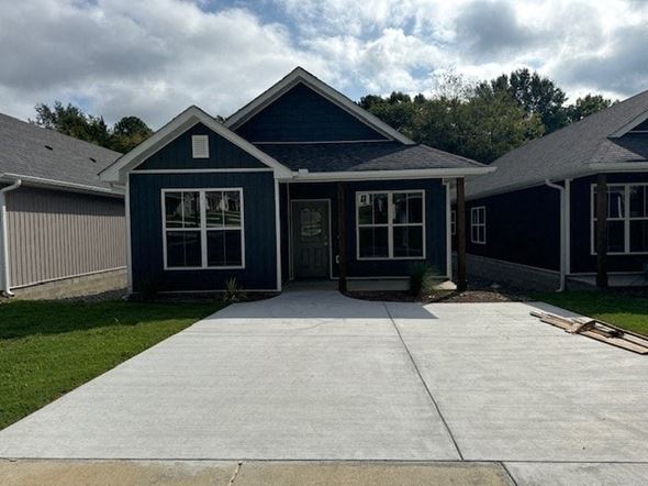Little Rock house for rent - A blue house with a grey roof and a grey garage door.