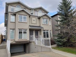 Calgary apartment for rent - A two-story house with a garage and a balcony.