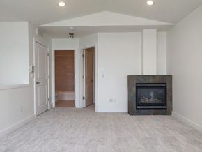Calgary apartment for rent - A living room with a fireplace and a carpeted floor.